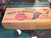 Photo of closed box labeled Dupe-a-goose folding decoys, showing brand and labeling.