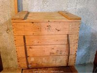 Closed view of solid wood crate showing latch, hinges, and wood grain.