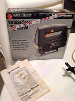 Black & Decker variable speed electronic jigsaw in box with instruction manual in front