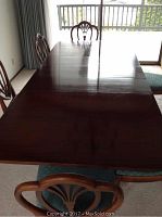 Image showing full view of six chairs surrounding the rectangular table extended with leaves.