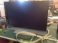 Front view of Vizio flat screen TV with HDMI cable placed on table