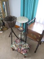 Photo of the five furniture items arranged: marble table, floral footstool, wooden cabinet, ashtray stand, and wicker basket stand against window with turquoise curtains and carpeted floor