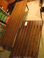 Overhead view of both slatted wood tables showing relative sizes