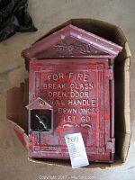Top-down closed view showing front door with embossed instructions and small broken glass section