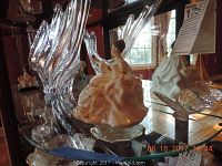 Crystal vase, Royal Doulton My Love figurine, and elephant figurine on glass shelf