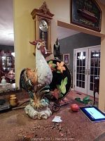 Two ceramic rooster figurines and floral decorative plate shown on countertop with visible tags 237 and 238.