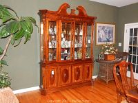 Full front view of breakfront cabinet in room setting