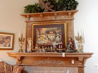 Mantel display showing framed print, both candelabras, large figurines and smaller porcelain figures