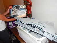 Partially assembled top hull panels of the Imperial Star Destroyer set with instruction manual visible behind.