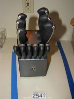 Front view of the set in black block showing knife handles and Henckels logo