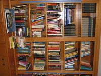 Bookshelves filled with various vintage and collectible books including Hardy Boys titles and assorted literature.
