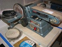 Full view of Collins combination belt and disc sander with sanding belt and disc visible, includes circular sanding disc accessory packaged in plastic.