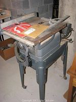 Full view of the Craftsman bench saw showing the flat metal worktable, adjustment wheels, and sturdy legs.