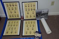 Four black-framed aircraft silhouette training posters with beige background, two without glass arranged on carpet with books nearby.