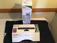 Xbox Kinect sensor bar and Kinect mount stand with original boxes and instructions on display.