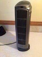 Front view of Lasko tower-style space heater revealing front grill and overall height