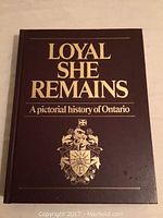 Front cover of the book titled 'Loyal She Remains: A pictorial history of Ontario' with gold embossed text and crest on dark brown hardcover.