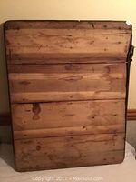 Top view of the wooden table top showing wood grain, knots, and some stains and discolorations on the surface.
