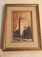 Front view of framed print titled "Grant Hall, Queens" depicting a building with clock tower, gold frame and beige linen matting.