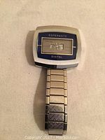 Front view of the vintage Esperanto 17 jewel digital wristwatch showing rectangular steel case, blue-bordered dial with mechanical digital windows, and metal link bracelet.