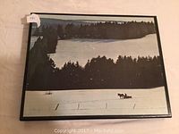 Large coffee table book with a winter landscape image on the protective sleeve showing snow-covered fields, trees in the background, and a horse-drawn sleigh.