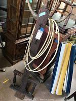 Full view of the wooden hall tree showing front profile with horn hooks, carved detailing, and base structure.