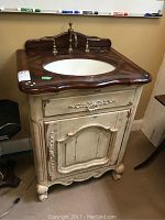 Front view of Hooker vanity cabinet with sink and backsplash