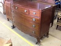 Front angle view of dresser showing bow-front shape and drawer layout