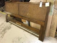 Full view of the wood headboard showing rattan center panel, legs, and bottom support.