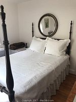 Front view of the full size vintage 4 poster bed with white quilt and pillows, showing turned posts and headboard.