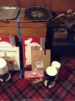 Photo showing boxed turkey platter set and lazy susan with other items on carpeted floor.