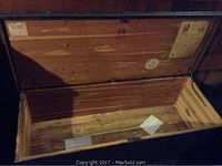 Interior of Lane cedar chest showing cedar lining, labels, and papers inside.
