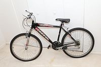 Side profile of the complete black Huffy Highlands mountain bike showing frame design and tire size.