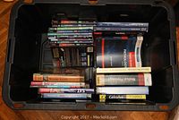 Plastic tote filled with various medical and academic textbooks stacked neatly inside.