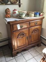 Full view of Kincaid oak buffet cabinet with two drawers and two doors, showing front carved details and hardware