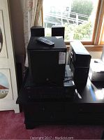 Overall view of Yamaha AV receiver with remote on top, subwoofer, and speakers arranged nearby showing physical condition.