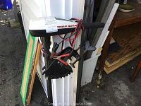 Full view of Minn Kota electric trolling motor showing head casing with brand logo and wiring harness.