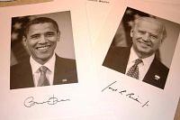 Close up photo of black and white signed portraits of Barack Obama and Joe Biden