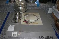 Top-down view showing two pewter Jefferson cups, one pewter bowl, and Oneida silverplate tray with box underneath.