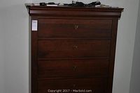 Front view of upper three drawers and top molding illustrating finish and drawer hardware.