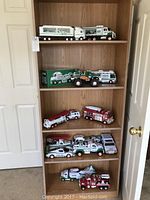 Full view of woodgrain five-shelf bookcase holding all toy vehicles