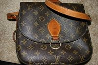 Front exterior view of Louis Vuitton monogram canvas shoulder bag with flap closed