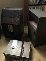 Overall view of two Bose Model 901 speakers showing wood finish, black grille cloth, and the Bose Model 901 active equalizer with cable in front.