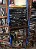 Stack of CD box sets including Bessie Smith The Complete Recordings Vol. 1 and 2, Robert Johnson The Complete Recordings, Elmore James King of the Slide Guitar, Donovan Troubadour, and more on a dark brown wood shelf.