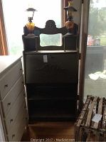 Front view of the vintage wooden secretary desk with mirror and two lamps on top.