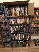 Overall view of shelving unit and cardboard box packed with DVD cases