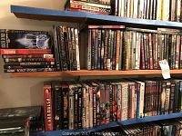 Three shelves filled with rows of science fiction DVD cases