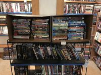 Full shelving of assorted DVDs and box sets across two levels