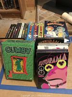 Collection of animation DVDs including Futurama, Gumby, and others arranged with some in original wrapping.
