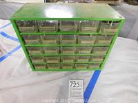 Front view of green metal storage container with 30 clear plastic drawers.